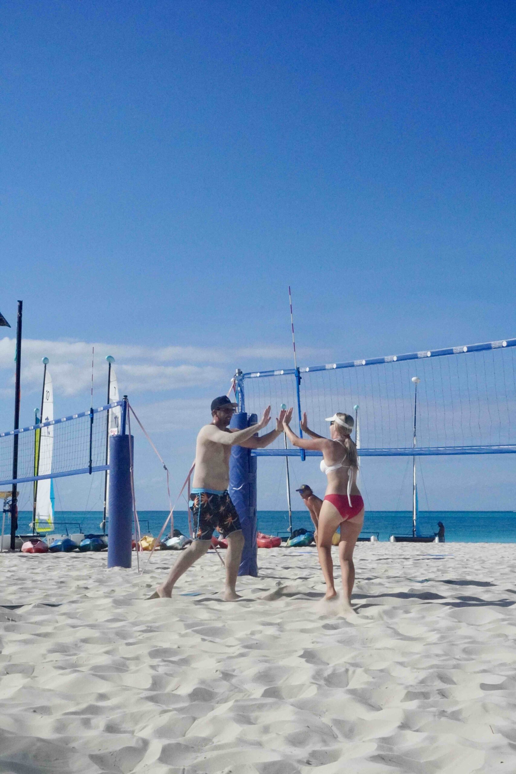 Sean "Rosie" Rosenthal gives high five to beach Volleyball Vacations camper